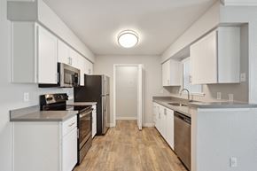 Rancho Cordova apartment for rent - A kitchen with white cabinets and stainless steel appliances.
