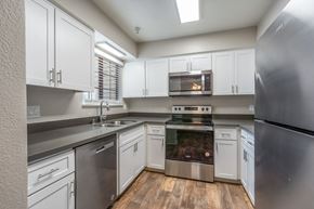 Sacramento apartment for rent - a kitchen with white cabinets and stainless steel appliances
