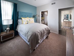 Dublin apartment for rent - A bedroom with a large bed and a lamp on a side table.
