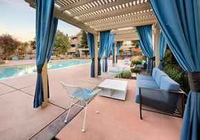 Dublin apartment for rent - A patio with a pool and blue curtains.