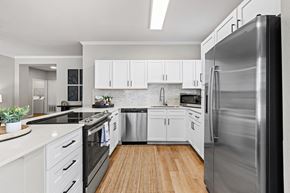 Parker apartment for rent - A modern kitchen with white cabinets and stainless steel appliances.