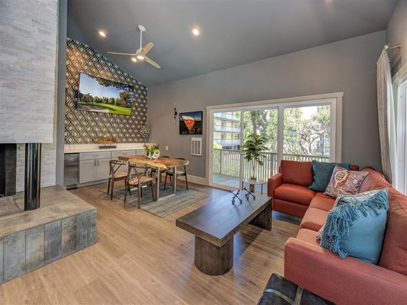 Alameda apartment for rent - A living room with a fireplace and a television mounted on the wall.