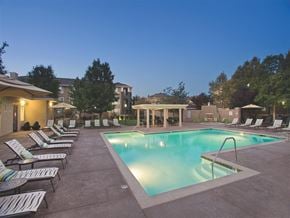 Antioch apartment for rent - A swimming pool surrounded by lounge chairs in a residential area.