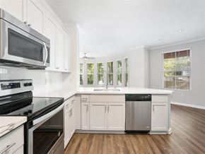 Concord apartment for rent - a white kitchen with a microwave and a sink