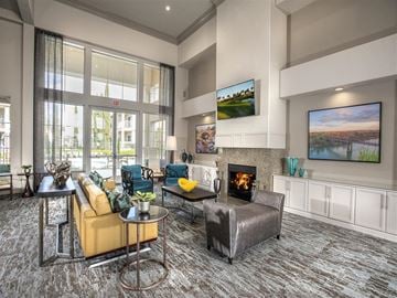 Folsom apartment for rent - A modern living room with a fireplace and a large painting on the wall.