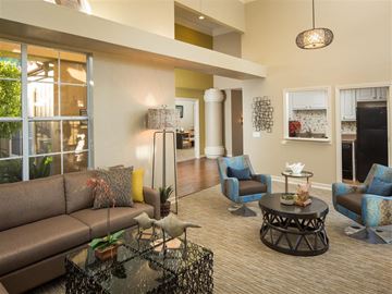 Laguna Niguel apartment for rent - A living room with a brown couch and blue chairs.