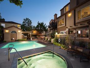 Laguna Niguel apartment for rent - A swimming pool surrounded by a fence and benches.