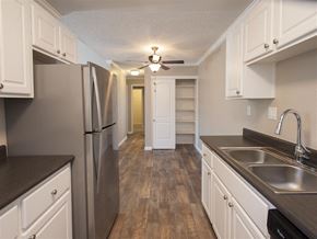 Martinez apartment for rent - A kitchen with white cabinets and a stainless steel refrigerator.