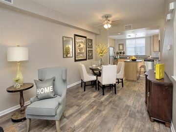 Petaluma apartment for rent - A living room with a grey chair and a table with a lamp on it.