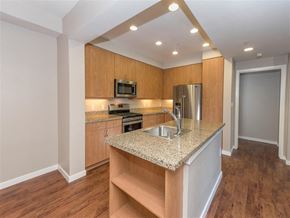 Petaluma apartment for rent - A kitchen with wooden cabinets and a granite countertop.