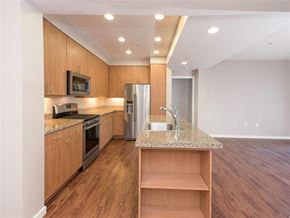 Petaluma apartment for rent - A kitchen with wooden cabinets and a granite countertop.