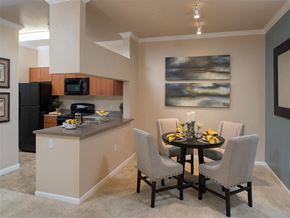 Riverside apartment for rent - A kitchen with a table and chairs set for two.