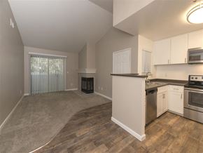 Rohnert Park apartment for rent - A kitchen with white cabinets and stainless steel appliances.