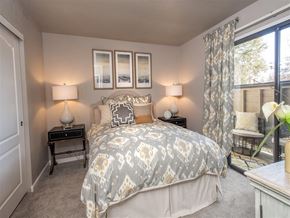 Roseville apartment for rent - A bedroom with a bed, nightstands, and a window.
