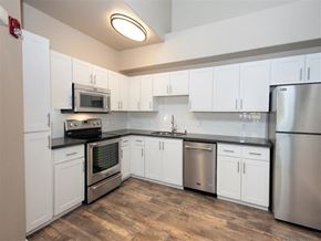 Roseville apartment for rent - A kitchen with white cabinets and stainless steel appliances.