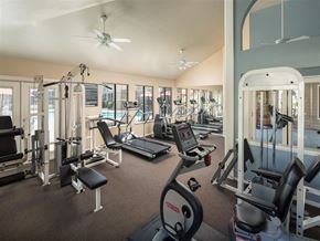 Sacramento apartment for rent - A gym with a variety of equipment including treadmills, weights, and exercise machines.