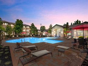 Sacramento apartment for rent - A pool surrounded by lounge chairs and umbrellas.