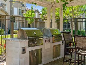 Sacramento apartment for rent - A BBQ grill is on a patio with a chair.
