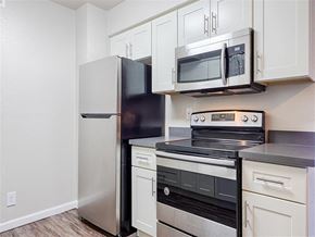 Santa Rosa apartment for rent - A kitchen with a black fridge, stainless steel oven, and microwave.