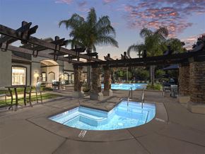 Vacaville apartment for rent - A pool area with a hot tub and a pergola.