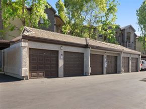 Vacaville apartment for rent - A row of garage doors in front of a building.