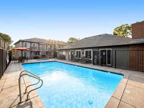 Vacaville apartment for rent - A swimming pool in a backyard with a metal fence.