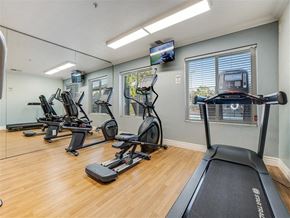 Vacaville apartment for rent - A gym with treadmills, elliptical machines, and a television.
