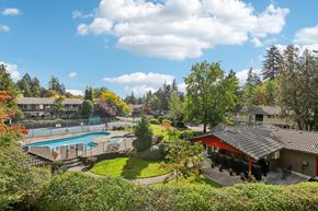 Vancouver apartment for rent - A view of a pool and a house from a hill.