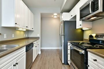 Dublin apartment for rent - A kitchen with white cabinets and stainless steel appliances.
