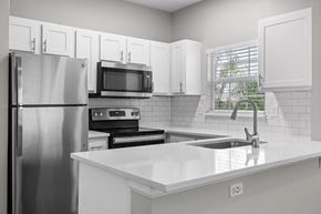 Greenwood Village apartment for rent - A kitchen with white cabinets and appliances.