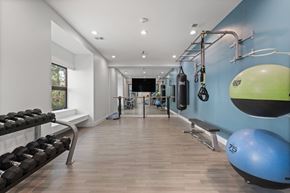 Greenwood Village apartment for rent - A gym with a blue wall and a bench.