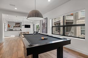Greenwood Village apartment for rent - A pool table is in the middle of a room with a light hanging from the ceiling.