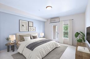 Tigard apartment for rent - A bedroom with a large bed and a window with curtains.