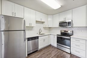 Alameda apartment for rent - a kitchen with white cabinets and stainless steel appliances