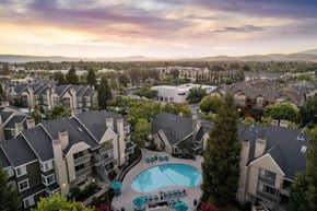 Livermore apartment for rent - A large apartment complex with a swimming pool in the foreground.
