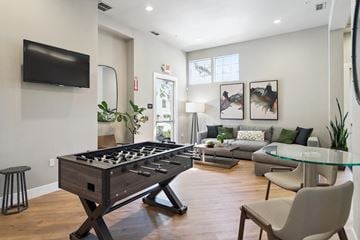 Livermore apartment for rent - A modern living room with a pool table and a television.