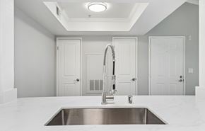 Livermore apartment for rent - A modern kitchen with a stainless steel sink and white cabinets.