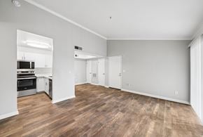 Livermore apartment for rent - A spacious room with wooden flooring and white walls.