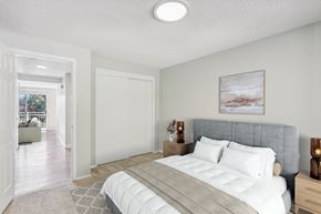 Vancouver apartment for rent - A bedroom with a large bed and a painting on the wall.