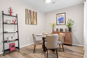 Lakewood apartment for rent - A dining room with a table set for two and a painting on the wall.