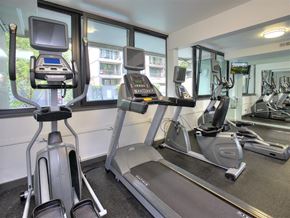 Portland apartment for rent - A gym with treadmills, exercise bikes, and a television.