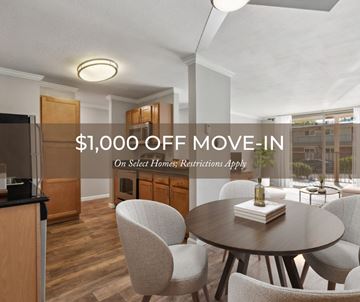 Walnut Creek apartment for rent - A modern kitchen with a dining table and chairs, offering a $1,000 off move-in deal on select homes.