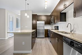 Greenwood Village apartment for rent - A modern kitchen with dark wood cabinets and stainless steel appliances.
