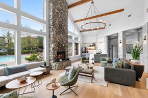 Happy Valley apartment for rent - A living room with a stone fireplace and a large window.