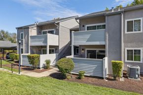 Martinez apartment for rent - A modern two-story apartment building with a well-maintained lawn and landscaping.