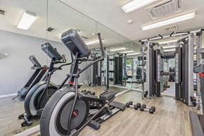Martinez apartment for rent - A gym with a row of stationary bikes and a mirrored wall.