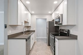 Martinez apartment for rent - A kitchen with white cabinets and stainless steel appliances.
