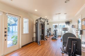 Pacific Grove apartment for rent - A home gym with a variety of equipment including treadmills, weights, and exercise machines.