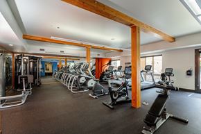 Hillsboro apartment for rent - a gym with cardio equipment and weights on the floor