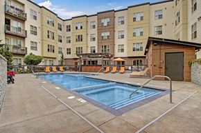Hillsboro apartment for rent - a swimming pool in front of a large apartment building